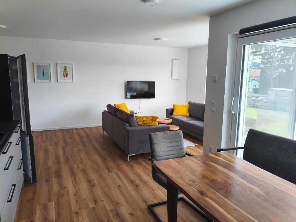 a living room with a couch and a table at Alpenblick Living in Stetten