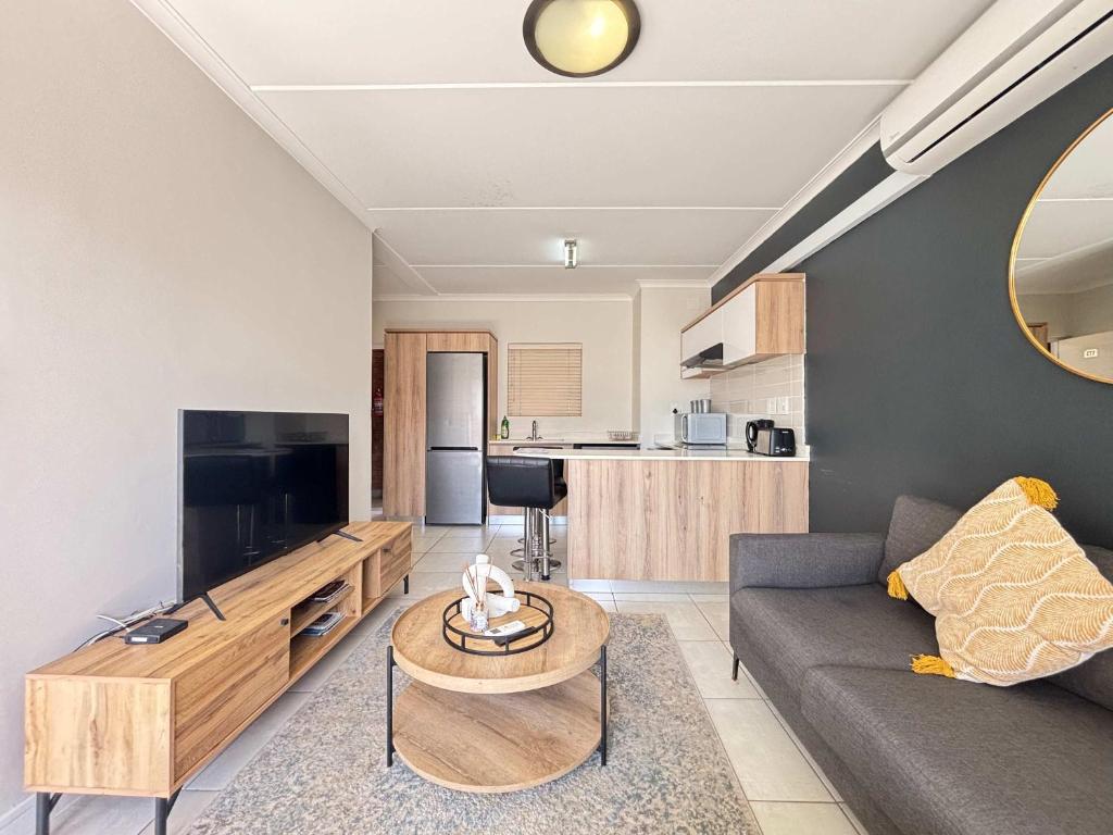 a living room with a couch and a table at Onyx Oasis in Ballito