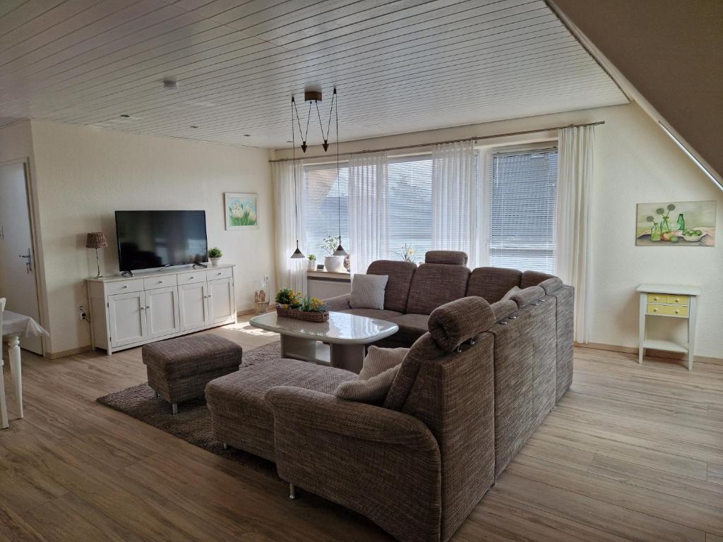ein Wohnzimmer mit Sofa und Fernseher in der Unterkunft FeWo Hofmann in Schwanewede