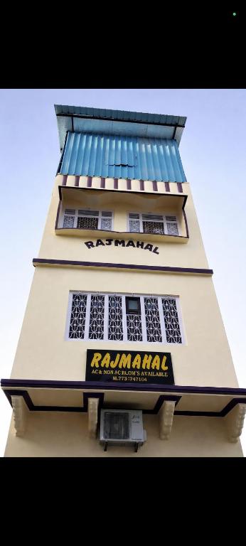 a tall building with a sign on the side of it at Hotel Rajmahal in Ajmer