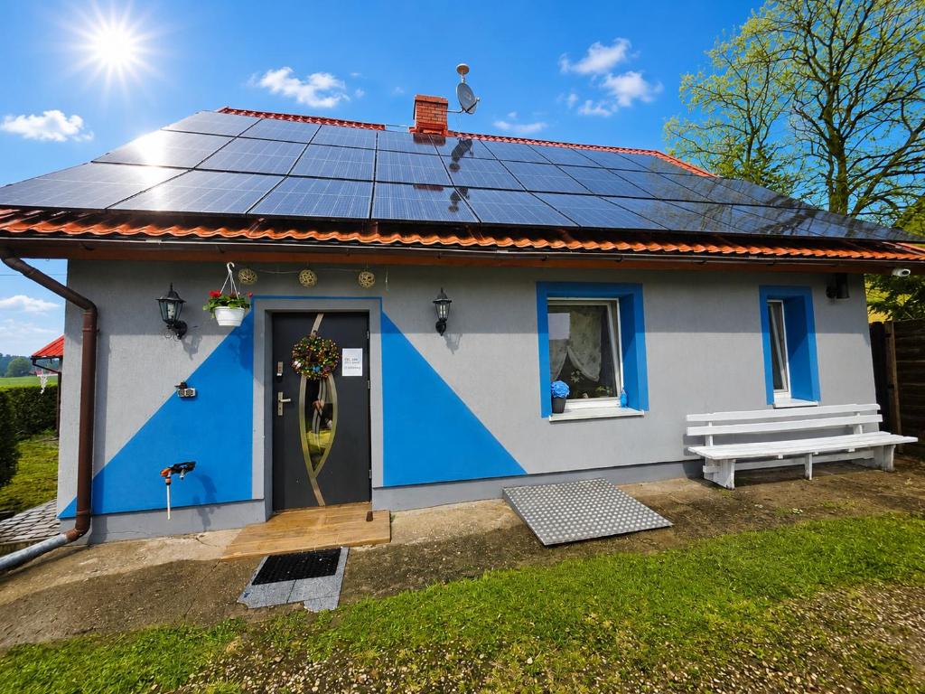 a small house with solar panels on the roof at Chill House Lipowo Mazury in Lipowo