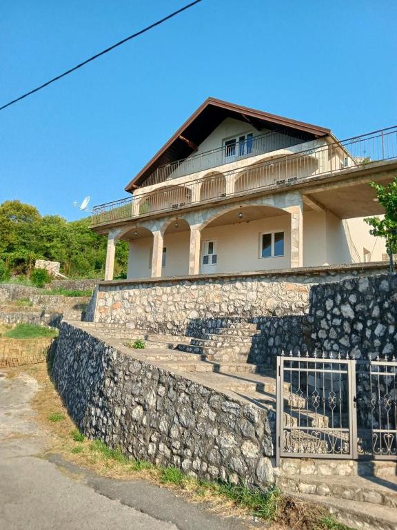 a stone retaining wall in front of a house at Villa Marija in Cetinje