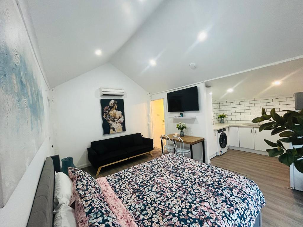 a bedroom with a bed and a couch at Cowra Guest House in Cowra