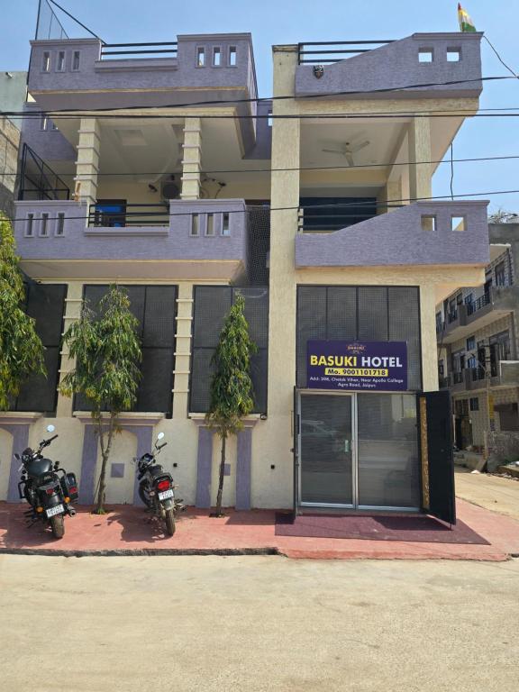 two motorcycles parked in front of a building at Basuki Hotel in Jaipur