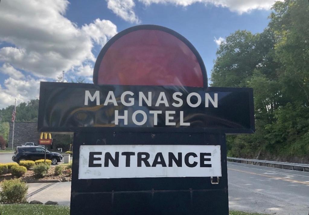 a sign for a macaroon hotel on the side of a road at Magnason Hotel in West Liberty