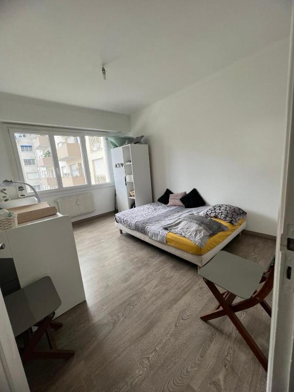 a bedroom with a bed in the middle of a room at Chambre d'hôte Cannes in Le Cannet