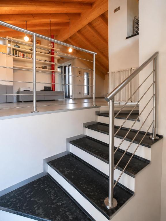 a staircase in a house with wooden ceilings at Mansarda Boutique May in Bergamo