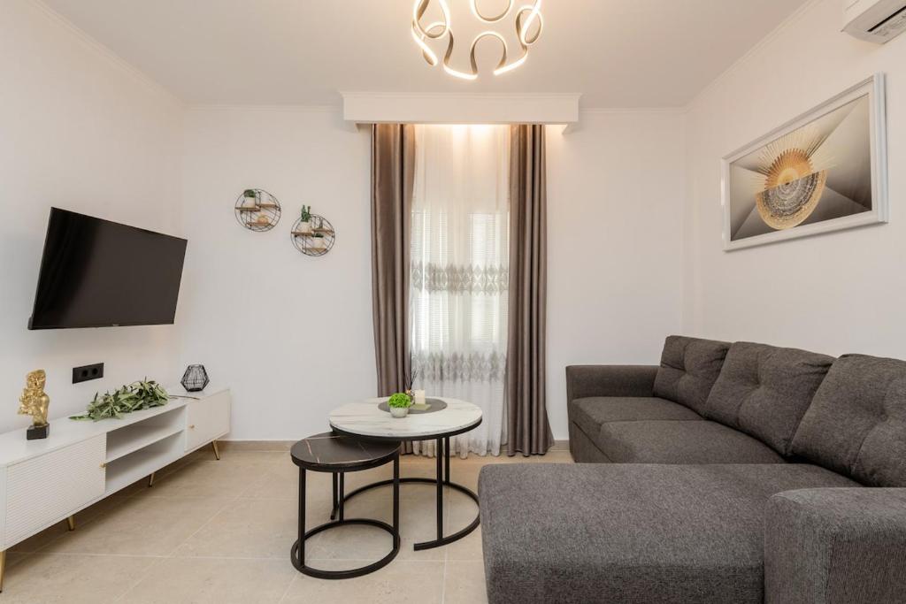 a living room with a couch and a table at M&A Boutique House in Zakynthos