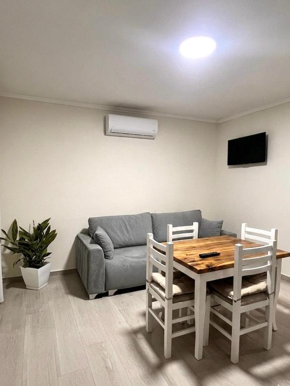 a living room with a table and a couch at Floor Villa 2 in Vlorë