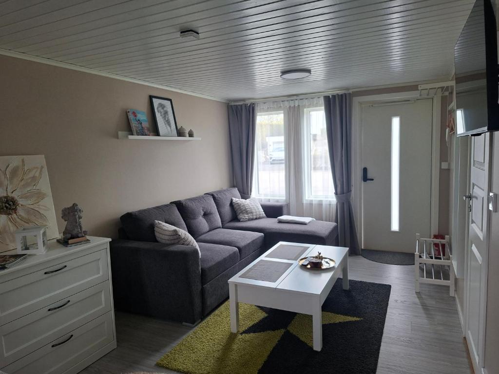 a living room with a couch and a table at Boende i Falkenberg in Falkenberg