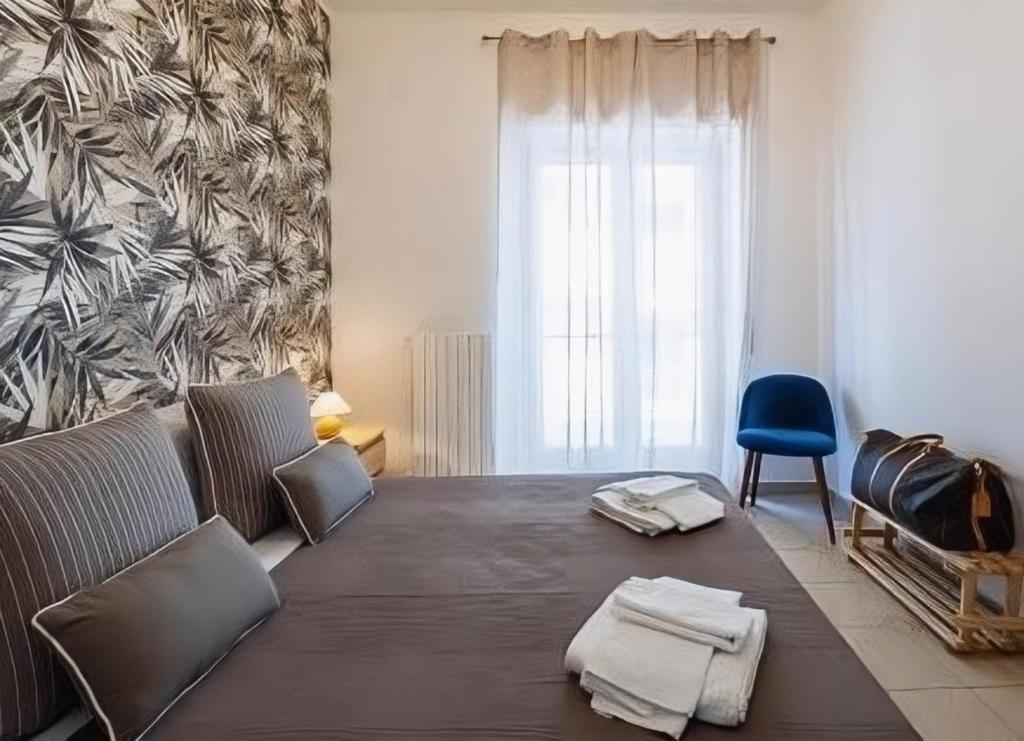 a living room with a couch and a blue chair at Aranci 99 House in Sorrento