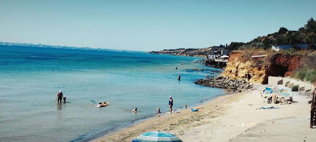 a group of people in the water at a beach at Dacha Marella in Nova Dofinivka