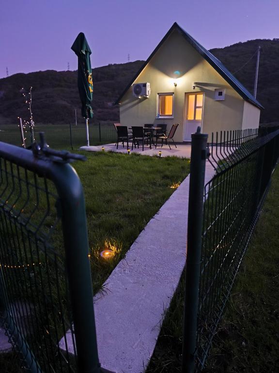 a fence in front of a house with a yard at Home Delic Komarnica in Šavnik