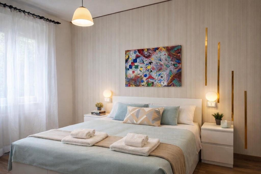 a bedroom with a large bed with towels on it at Hotel Villa Pina in Senigallia