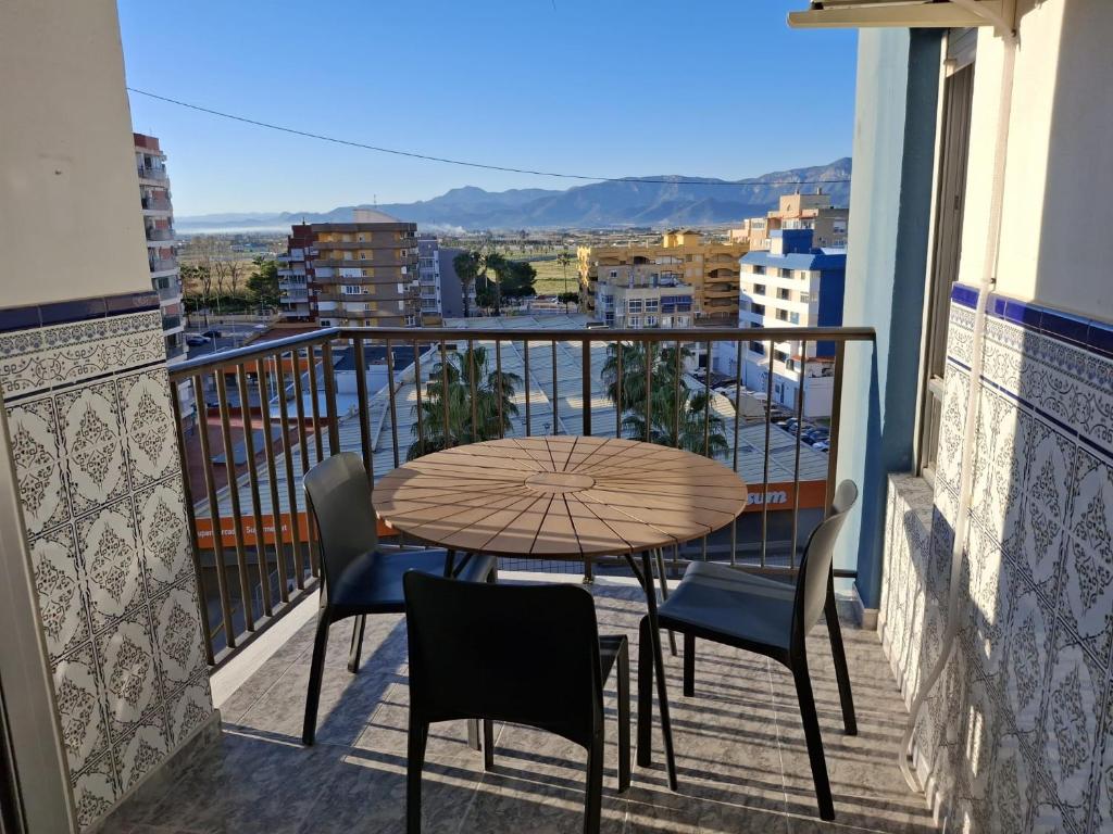 a table and chairs on a balcony with a view at Sea and Sun con vistas a la playa San Antoni in Cullera