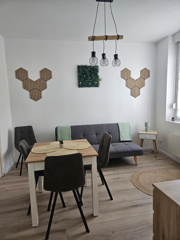 a living room with a table and a couch at 3-room apartment 2b in Thionville