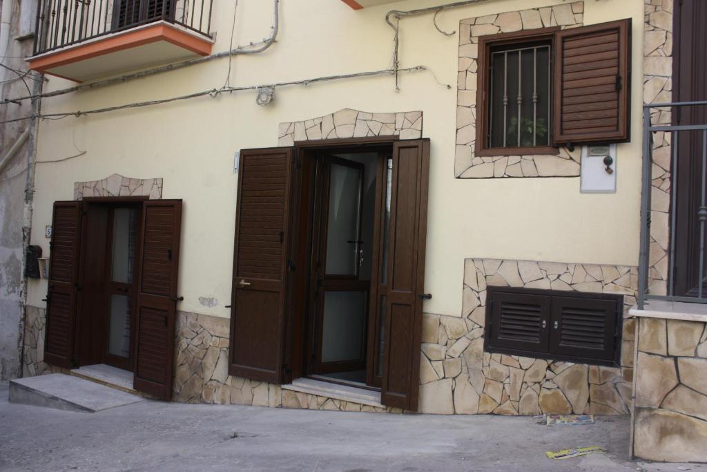 un edificio con puertas y ventanas marrones en Iaia Apartment, en Sciacca