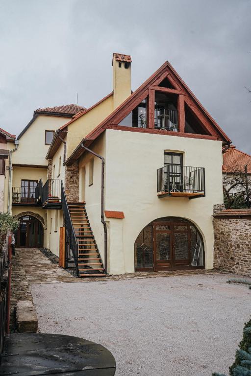 a large white house with a garage at genius loci apartments in Levoča