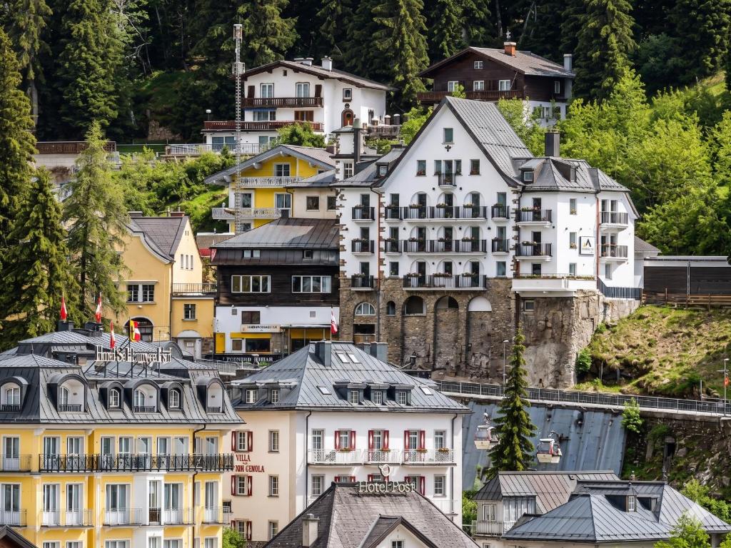a group of houses on a hill with trees at Hindenburg-Dependance Hotel Krone in Bad Gastein