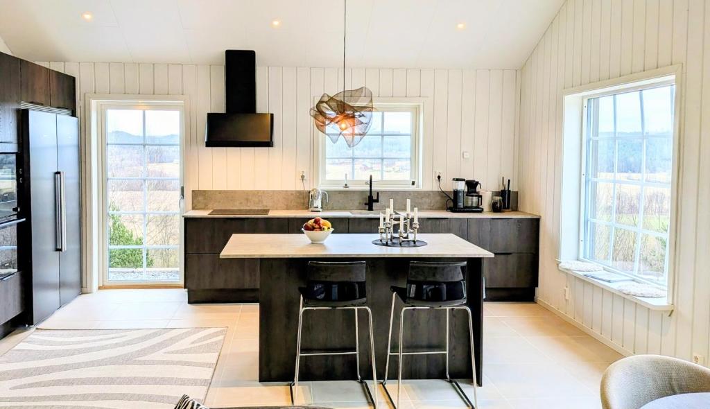 a kitchen with a large island in the middle at Backahöjd Holidays in Rävlanda