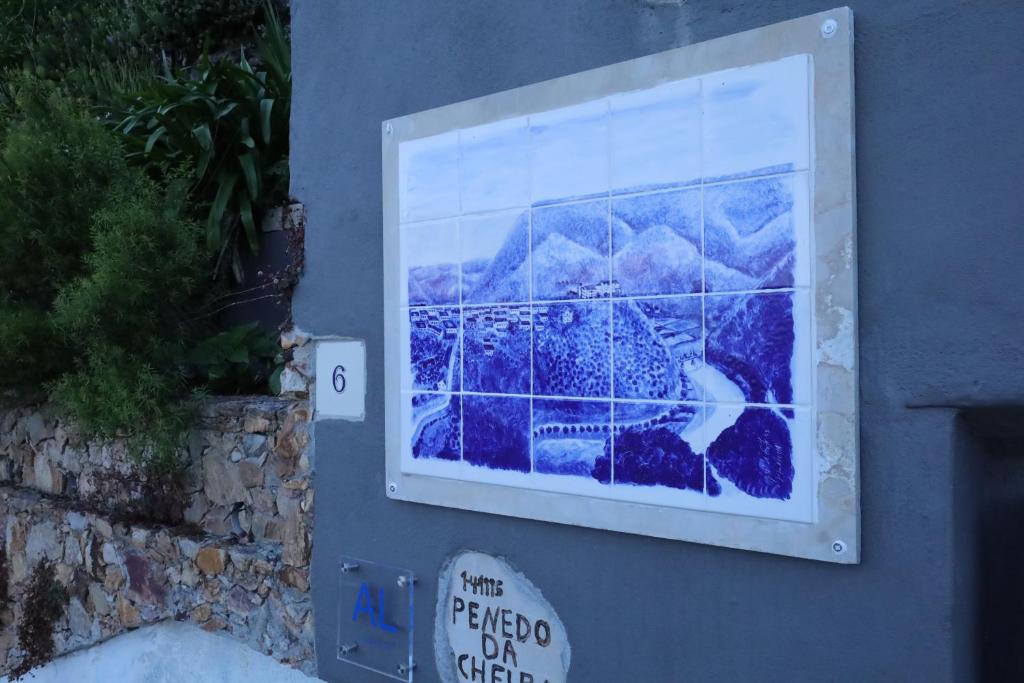 a sign on the side of a building with a picture at AL Penedo da Cheira in Penacova