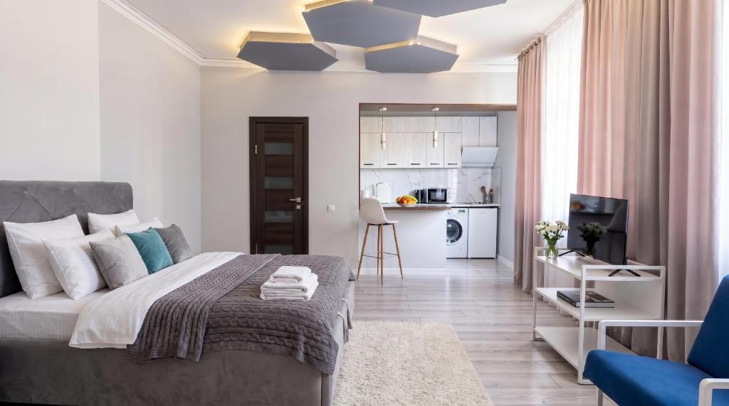 a bedroom with a bed and a living room at 40 m2 Confort apartament in Bălţi