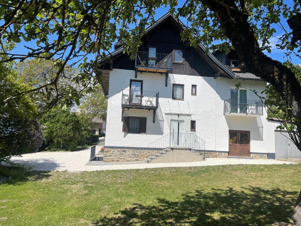 a white house with a black roof at Pension Victoria in Millstatt
