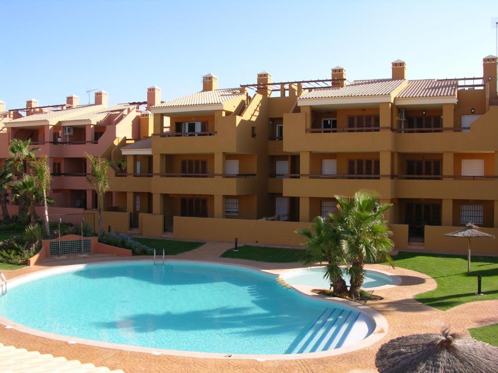 a swimming pool in front of a large apartment building at Albatros Playa 3 - 6008 in Mar de Cristal