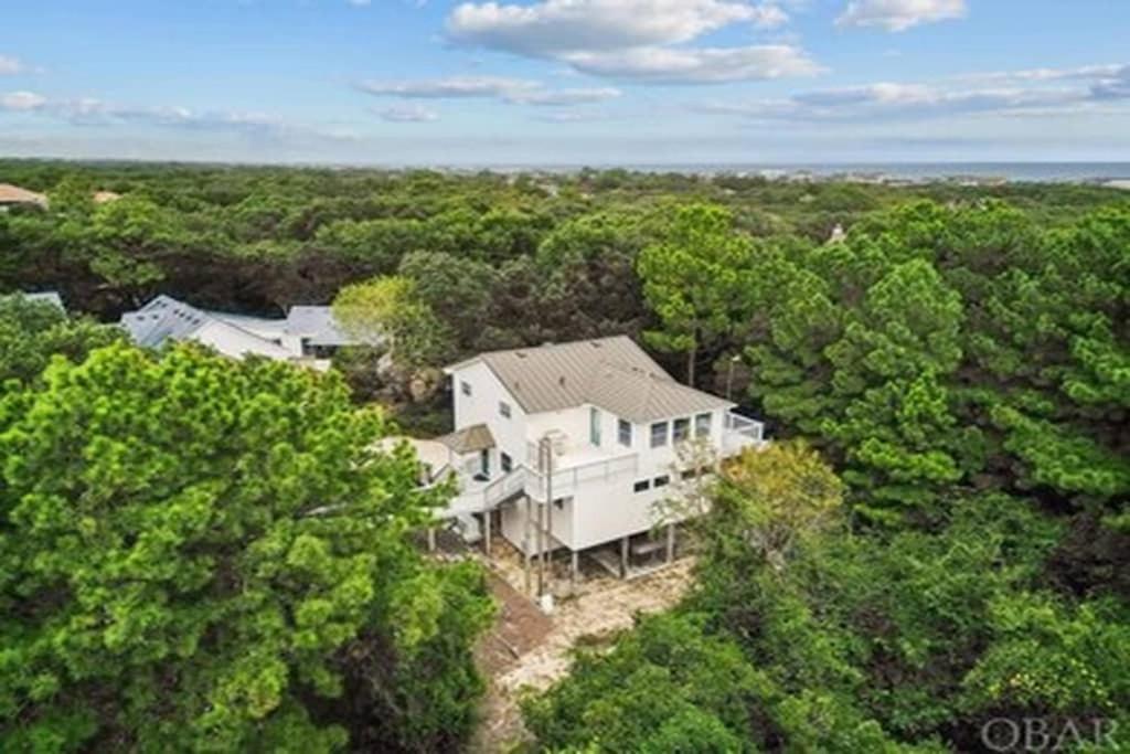 an aerial view of a large white house in the woods at 3BR 3BA Beach House in Kitty Hawk Beach
