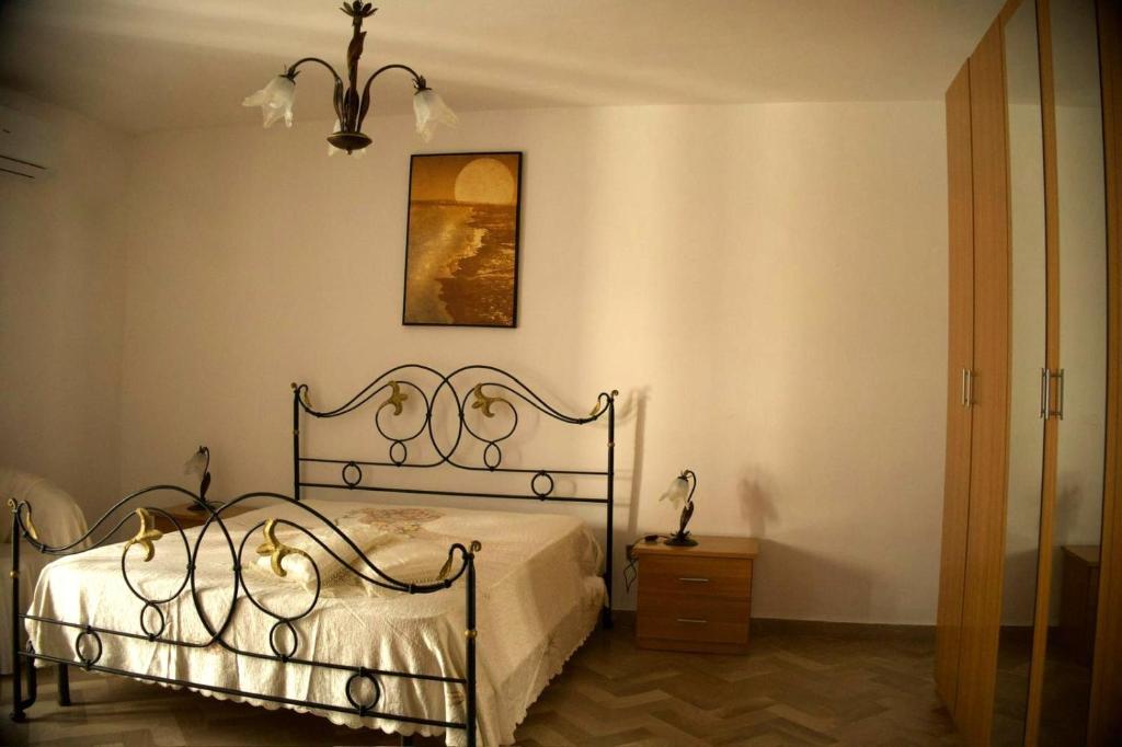 a bedroom with a bed and a picture on the wall at Casa Luisa in Peschici