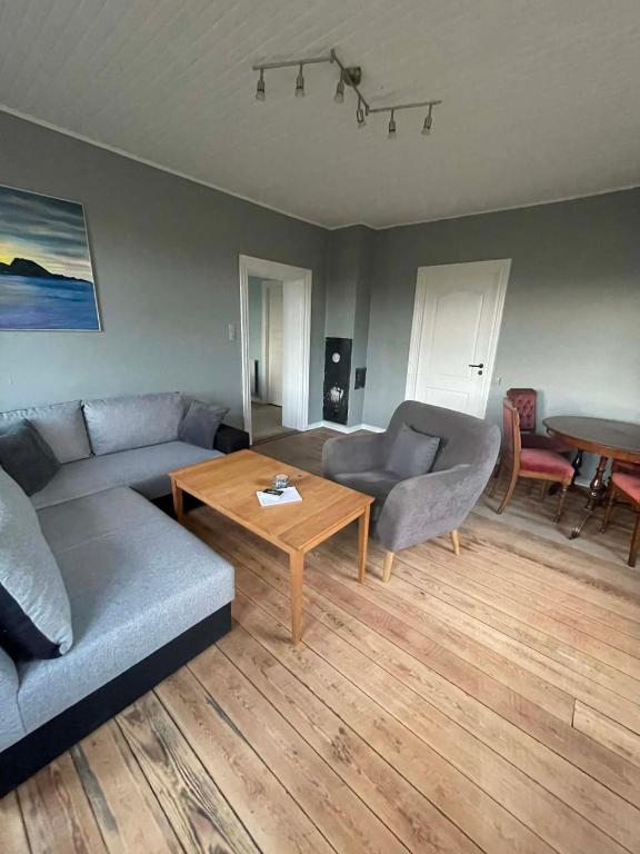 a living room with a couch and a table at Villa Katry in Augustenborg