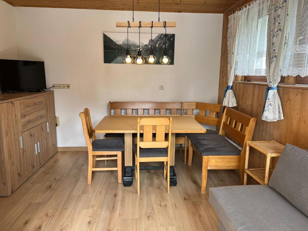 a dining room with a table and chairs and a couch at Haus Mader 3 in Riscone