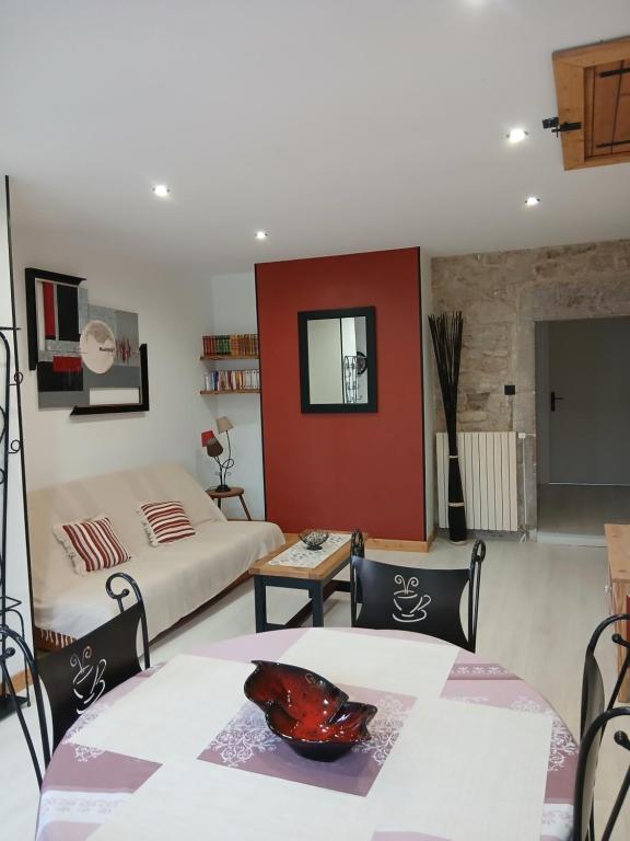 a bedroom with two beds and a table and chairs at Gite La Ferme in Arinthod