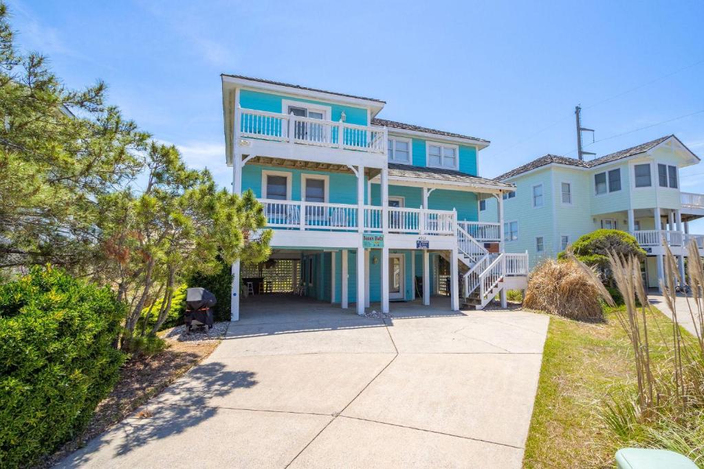 a large blue house with a balcony at Beach Nutz in Nags Head