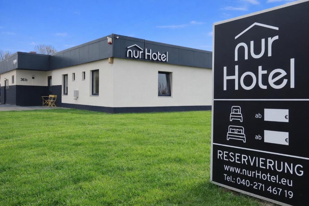 a building with a sign in front of it at nurHotel in Reinbek