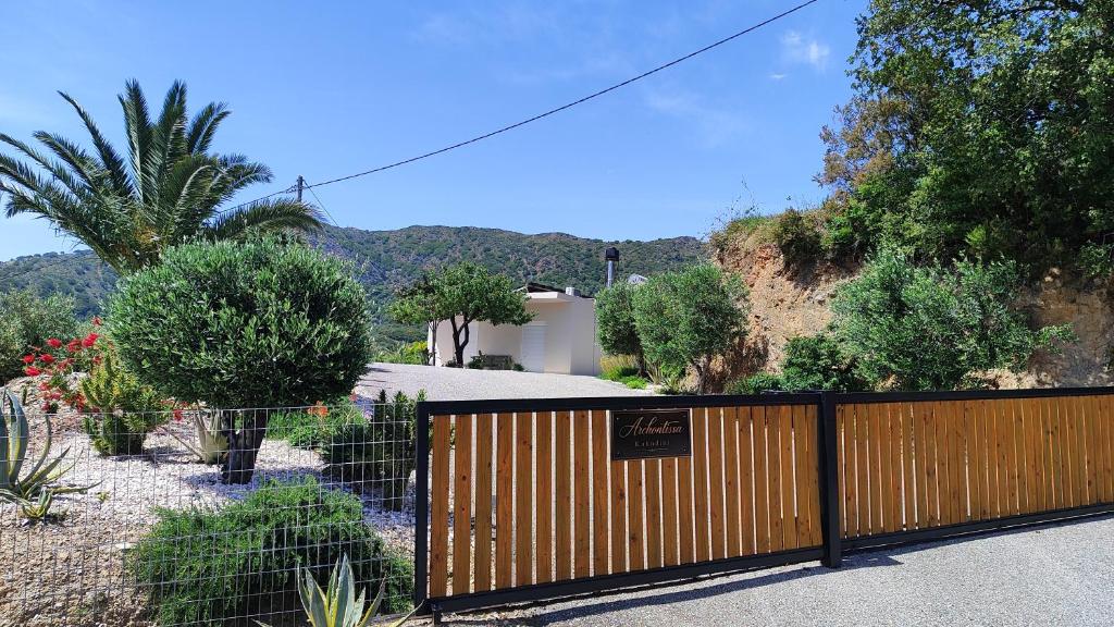 a fence with a sign on it next to a house at Archontissa Kakodiki - Paleochora in Palaiochora
