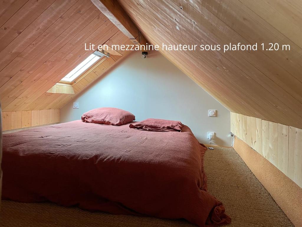 a bedroom with a bed in a attic at Le Cartot in Saint-Sauveur-dʼÉmalleville