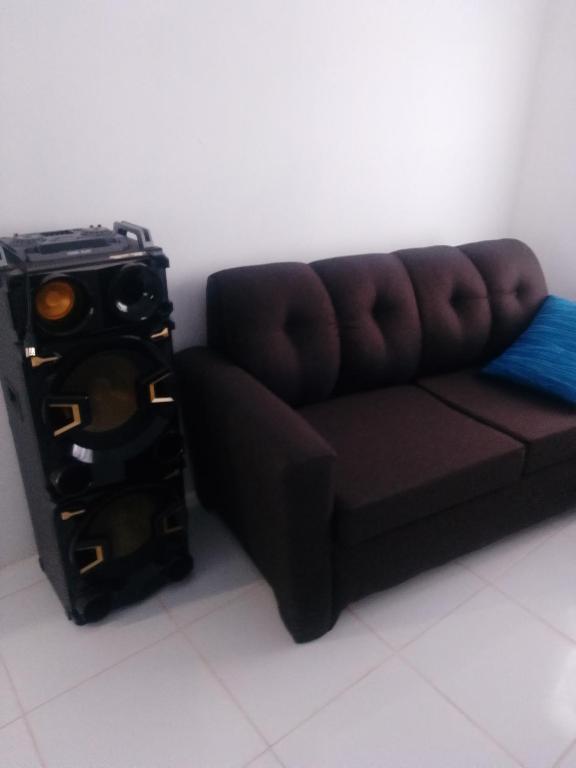 a brown couch sitting in a room at Blue Song Villa in Braco