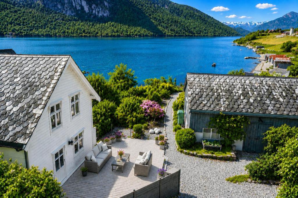 an aerial view of a house next to a lake at Villa Lilleheim in Breim