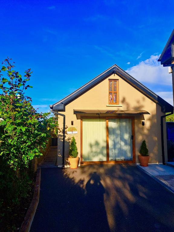 a house with a large window and a driveway at 9 Suíomh Alainn in Kilgarvan