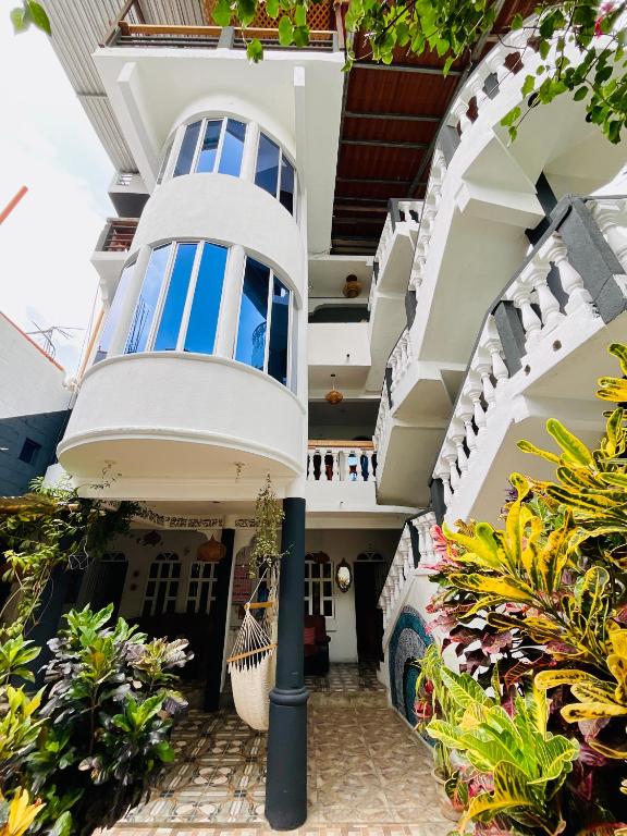 an external view of a house with balconies and plants at Mandala’s Hostal in San Pedro La Laguna
