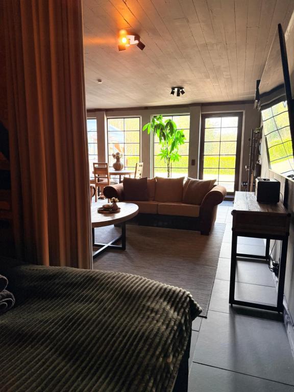 a living room with a couch and a table at Parkside studio in Hjo