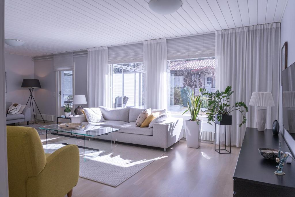 a living room with a couch and a table at Villa White Star in Rovaniemi