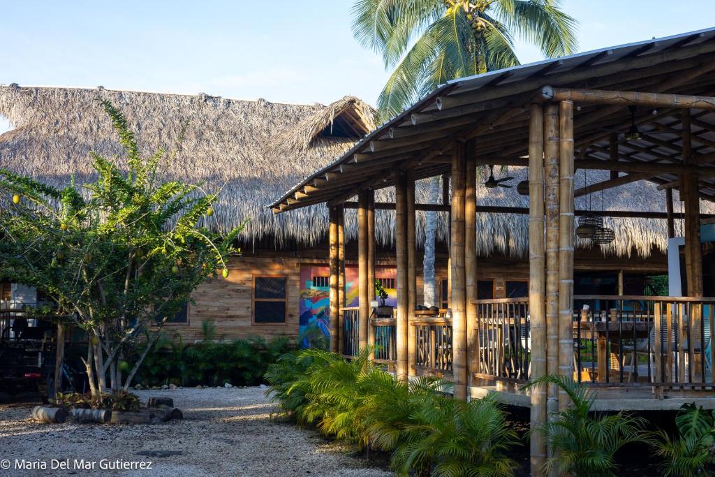 a resort building with a thatched roof at Rincón del Mangle in San Onofre