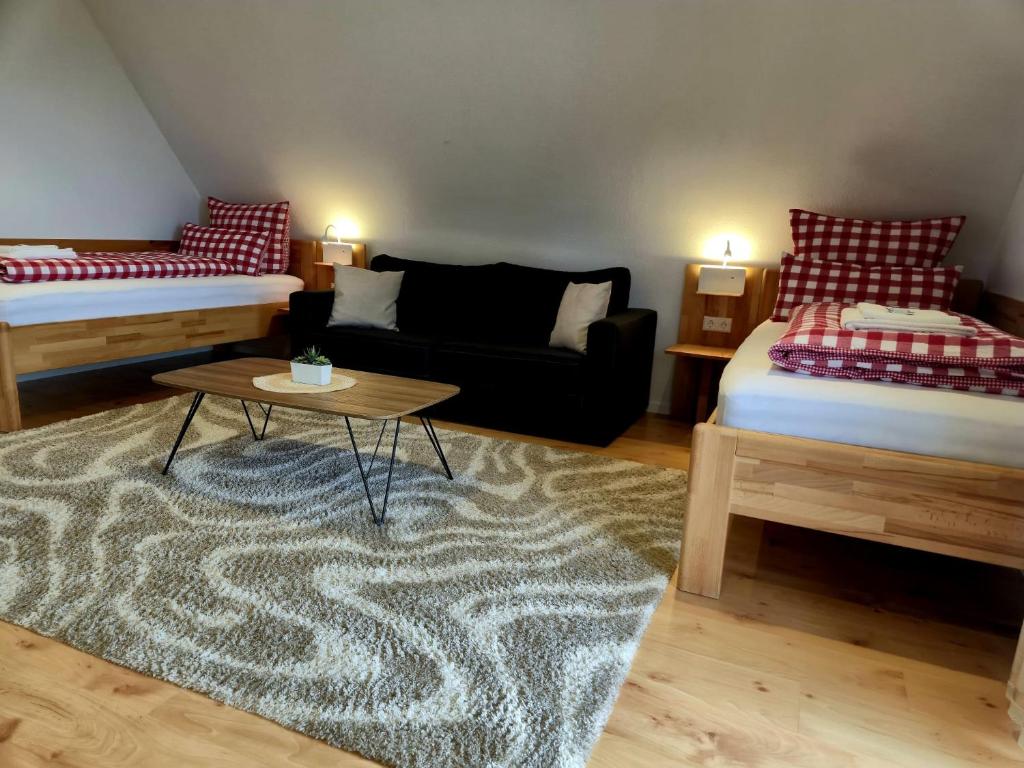 a living room with two beds and a coffee table at Renatas Ferienwohnung ISABEL in Sasbachwalden