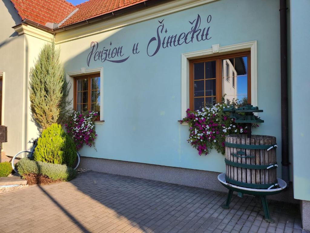 a blue building with a bench in front of it at Penzion u Šimečků in Šatov