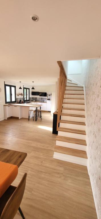 an open living room with stairs and a table at quiet house in Nogent-sur-Eure