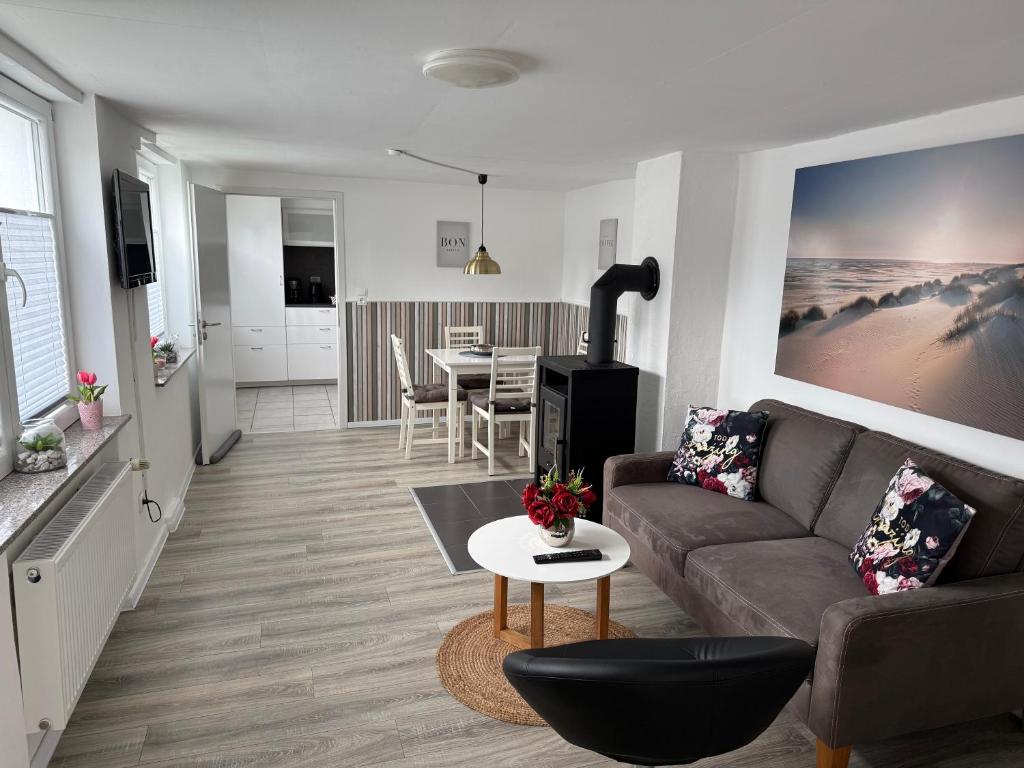 a living room with a couch and a table at Ferienapartment Stemmert in Gelting