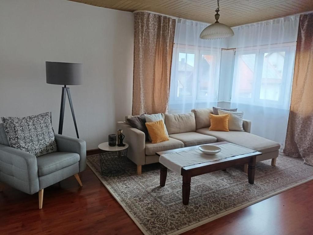 a living room with a couch and a coffee table at Gemütliche Ferienwohnung in Philippsburg