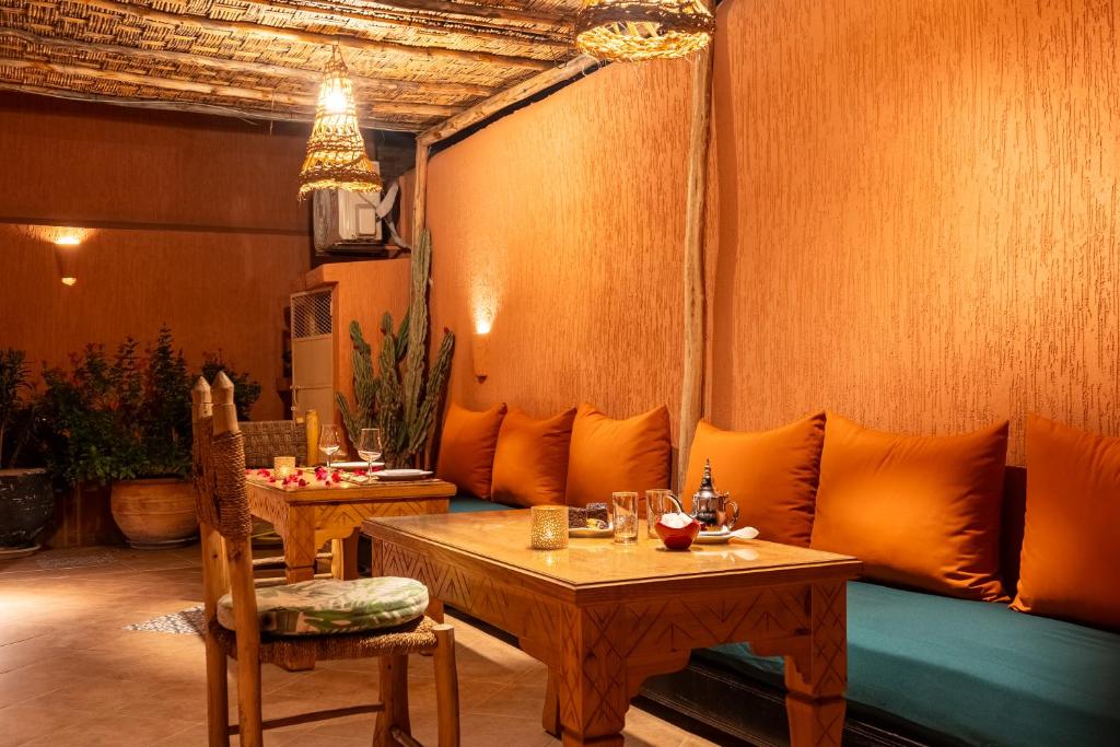a living room with two tables and a couch at Riad GUENAOUA Jacuzzi & Rooftop in Marrakesh